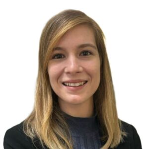 Professional headshot: smiling woman with shoulder-length blond hair in a dark blazer against a white background.