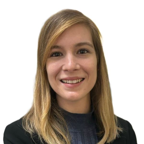 Professional headshot: smiling woman with shoulder-length blond hair in a dark blazer against a white background.